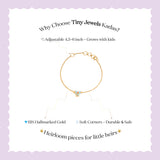 Tiny Jewels gold bracelet with text on a light purple background