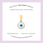 Tiny Jewels gold pendant with blue eye design on a white card with text about Tiny Jewels Pendants.