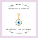 Tiny Jewels gold pendant with blue eye design on a white card with text about Tiny Jewels Pendants.