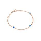 Tiny Jewels rose gold bracelet with blue beads on a white background