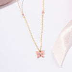 Tiny Jewels pink butterfly pendant necklace on a white background