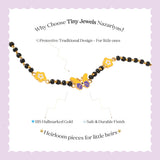 Tiny Jewels children's necklace with gold and black beads on a light purple background