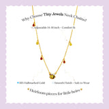 Tiny Jewels gold necklace with small stones on a light purple background, featuring text about the product.