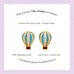 Tiny Jewels hot air balloon-shaped earrings on a light purple background with text about Tiny Jewels ear studs.