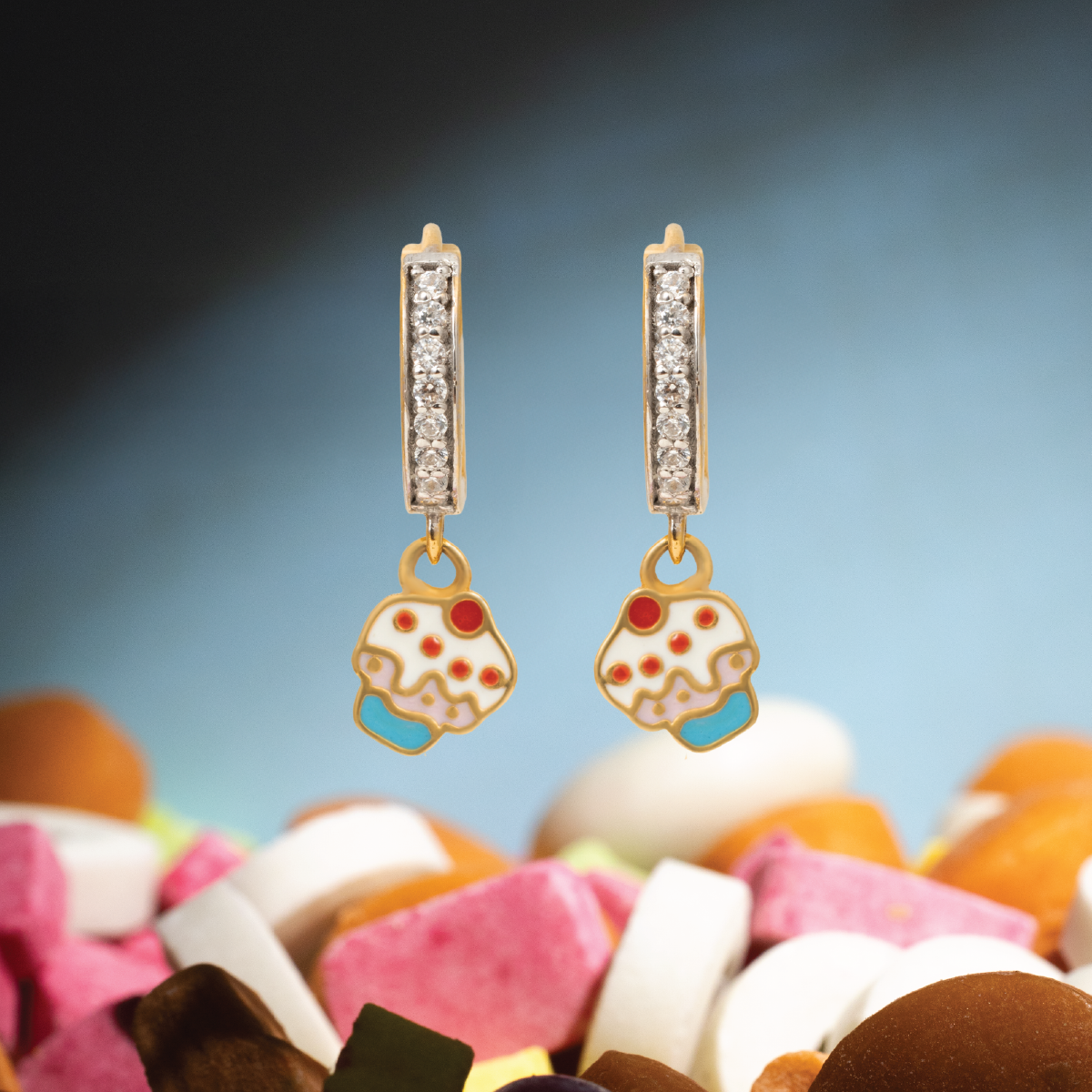 Tiny Jewels pair of earrings with donut charms on a colorful background