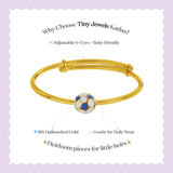 Tiny Jewels gold bracelet with a soccer ball charm on a light purple background, featuring text about Tiny Jewels Kadas.