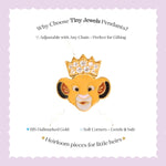 Tiny Jewels gold pendant shaped like a lion's head with a crown on a white background