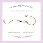 Tiny Jewels gold bracelet with black beads on a white background with promotional text about Tiny Jewels Nazariyas.