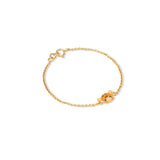 Tiny Jewels gold bracelet with a small gold charm on a white background