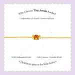 Tiny Jewels gold bracelet with a cartoon character on a white background with promotional text about Tiny Jewels Kadas.