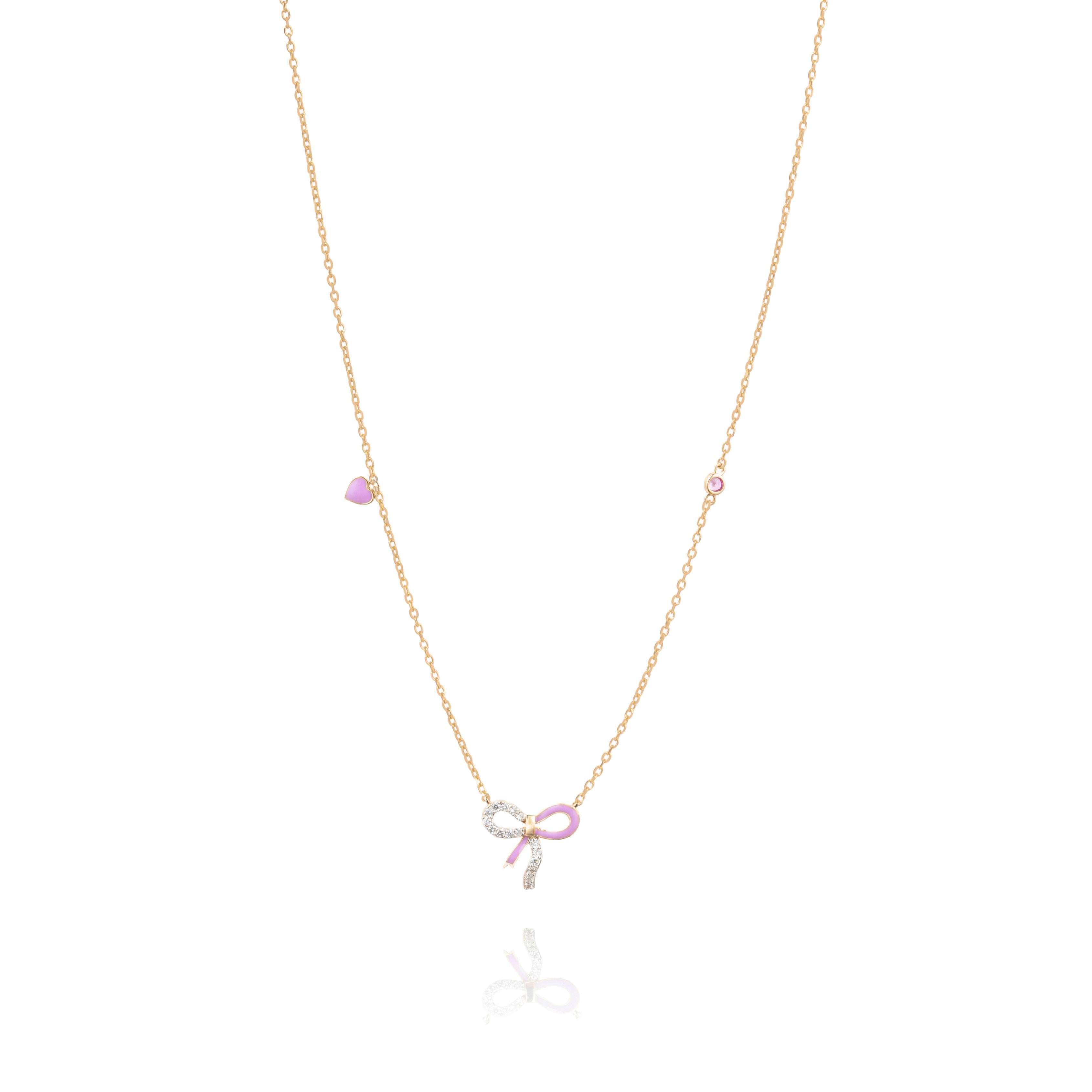 Tiny Jewels necklace with a pink bow charm on a white background