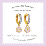 Tiny Jewels gold hoop earrings with flower charms on a purple background, featuring text about Tiny Jewels Balis.