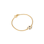Tiny Jewels gold bracelet with a blue and white sphere charm on a white background