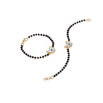 Tiny Jewels black beaded necklace with gold and blue butterfly pendants on a white background