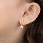 Tiny Jewels gold ice cream cone earring worn by a person