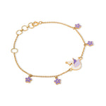 Tiny Jewels gold bracelet with purple flower charms on a white background