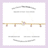 Tiny Jewels gold bracelet with charms on a white card with promotional text on a purple background