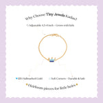 Tiny Jewels gold bracelet with a crown charm on a light purple background, featuring text about Tiny Jewels Kadas.