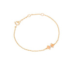 Tiny Jewels gold bracelet with a small bow-shaped clasp on a white background