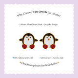Tiny Jewels penguin-shaped earrings with red hearts on a white background with text about Tiny Jewels ear studs.