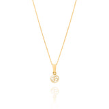 Tiny Jewels gold pendant with Om symbol on a white background