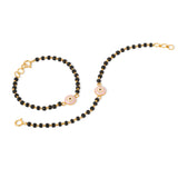 Tiny Jewels black beaded necklace with gold clasp and pink beads on a white background