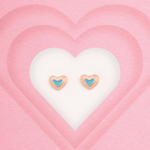 Tiny Jewels heart-shaped earrings with blue centers on a pink heart background