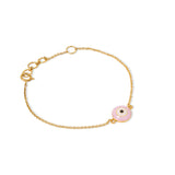 Tiny Jewels gold bracelet with a pink evil eye charm on a white background