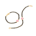 Tiny Jewels black beaded necklace with pink accents and gold clasps on a white background