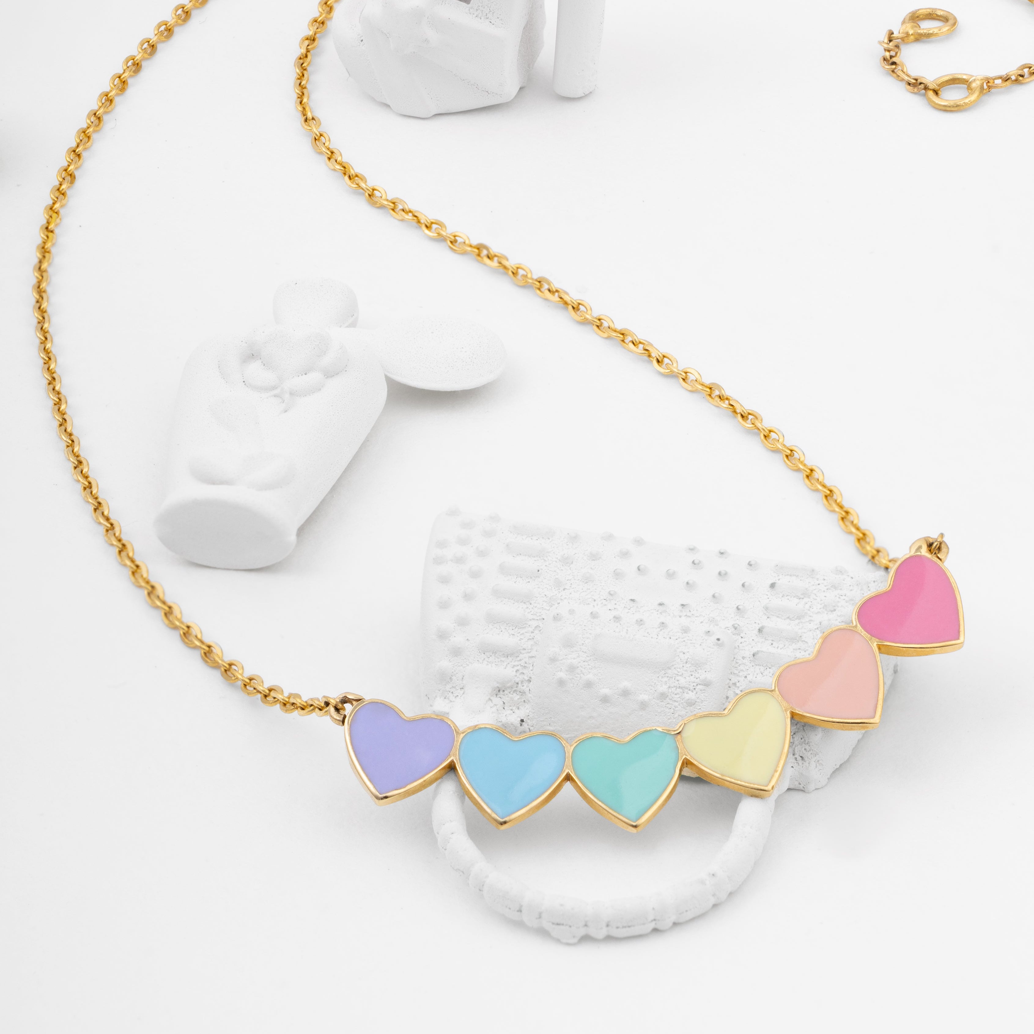 Tiny Jewels necklace with colorful heart-shaped pendants on a white surface