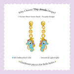 Tiny Jewels gold and turquoise seahorse-shaped earrings on a white background with promotional text.