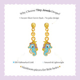 Tiny Jewels gold and turquoise seahorse-shaped earrings on a white background with promotional text.