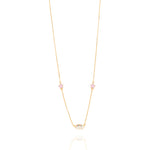 Tiny Jewels gold necklace with small colorful stones on a white background