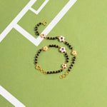 Tiny Jewels bracelet with floral beads on a green background