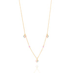 Tiny Jewels gold necklace with heart-shaped pendants on a white background