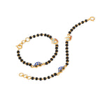 Tiny Jewels black beaded necklace with gold accents on a white background