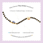 Tiny Jewels children's necklace with black beads and gold accents on a light purple background, featuring text about Tiny Jewels Nazariyas.
