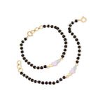 Tiny Jewels black beaded necklace with gold accents on a white background