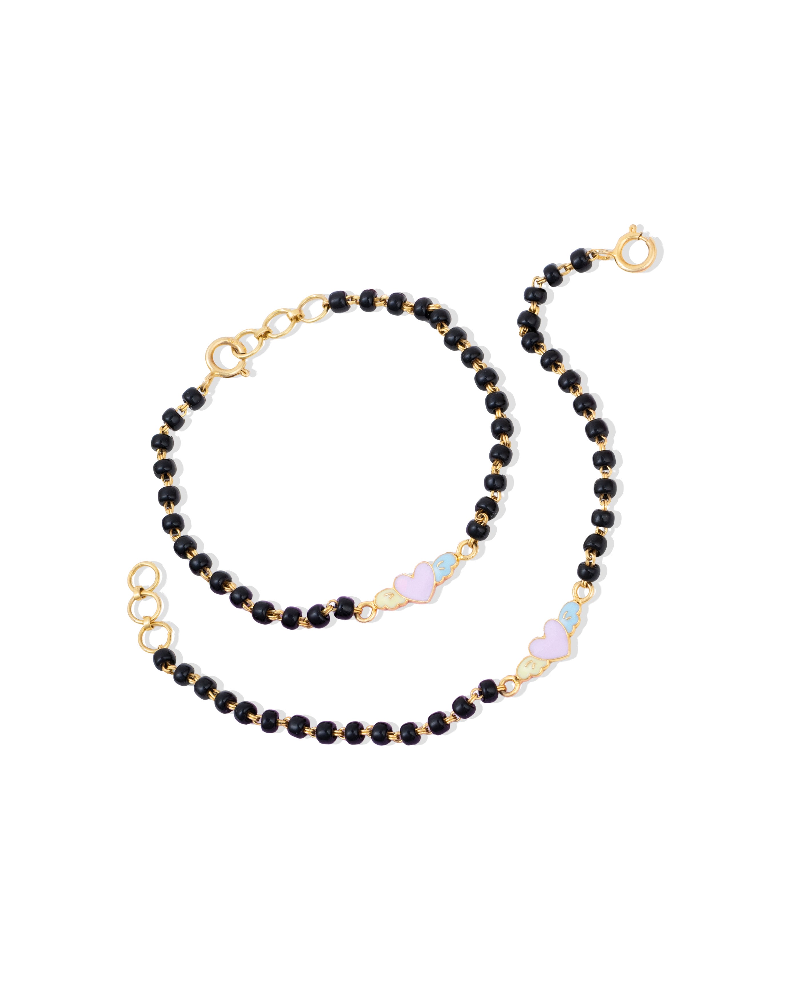 Tiny Jewels black beaded necklace with gold accents on a white background